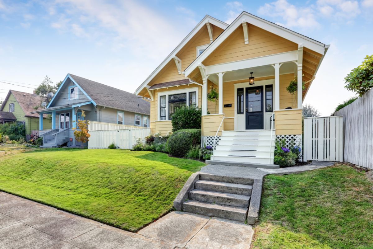 american craftsman home with yellow exterior paint